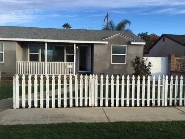 Ranch home with green lawn and carport