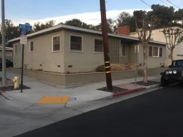 Stucco cottage with white picket fence