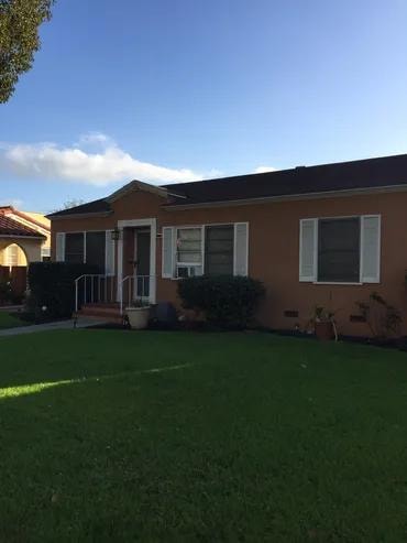 Brown single story house green lawn