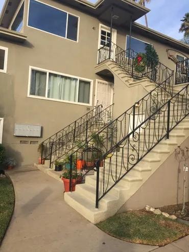 Beige house exterior with metal staircase