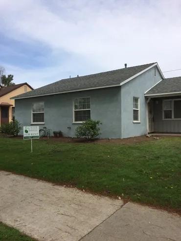Light blue residential house with lawn