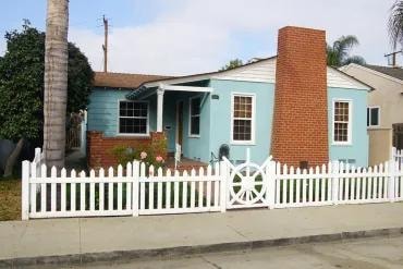 Light blue cottage white picket fence